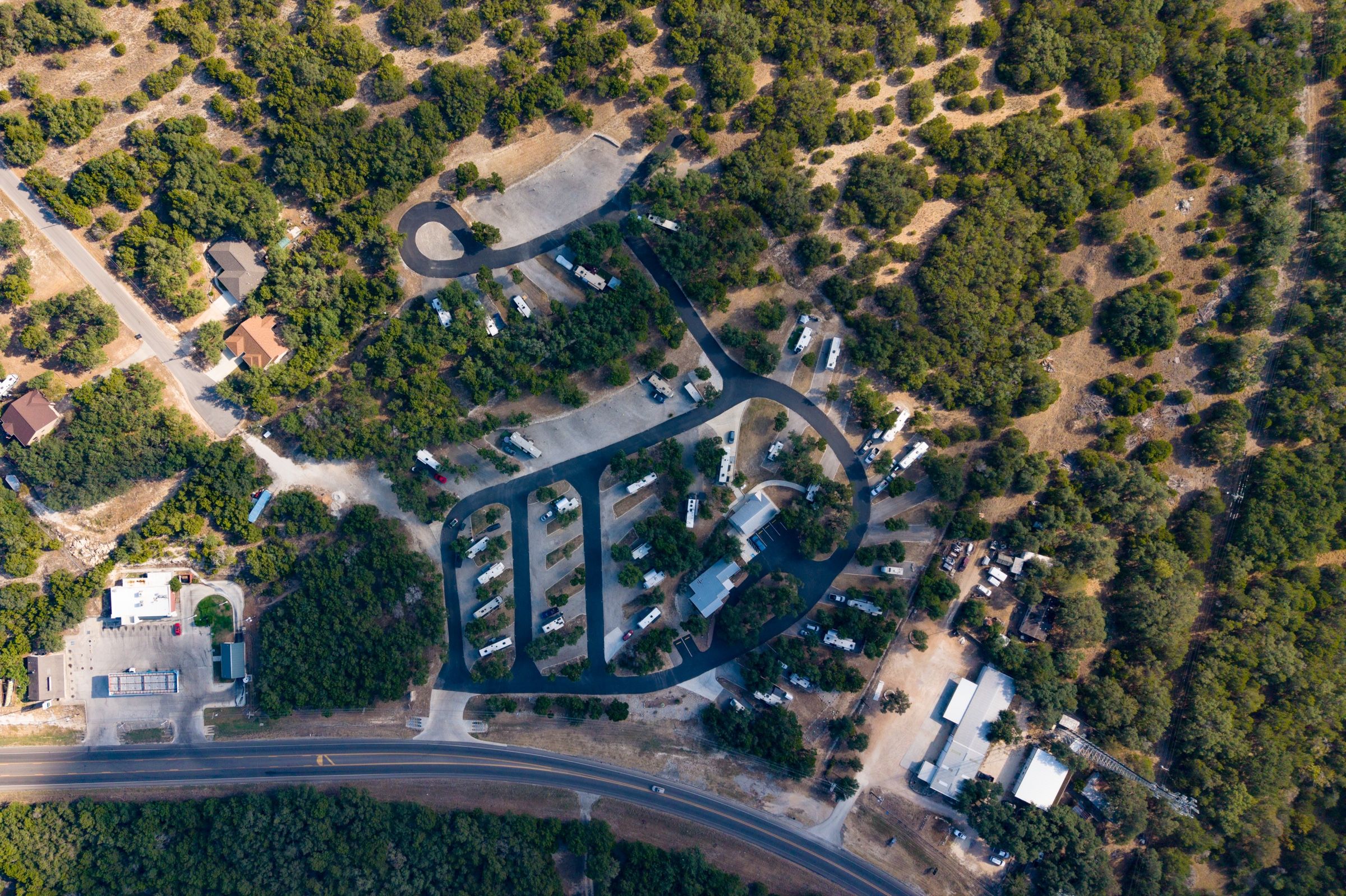 Overhead view of the park loops among the trees, with FM 306 below